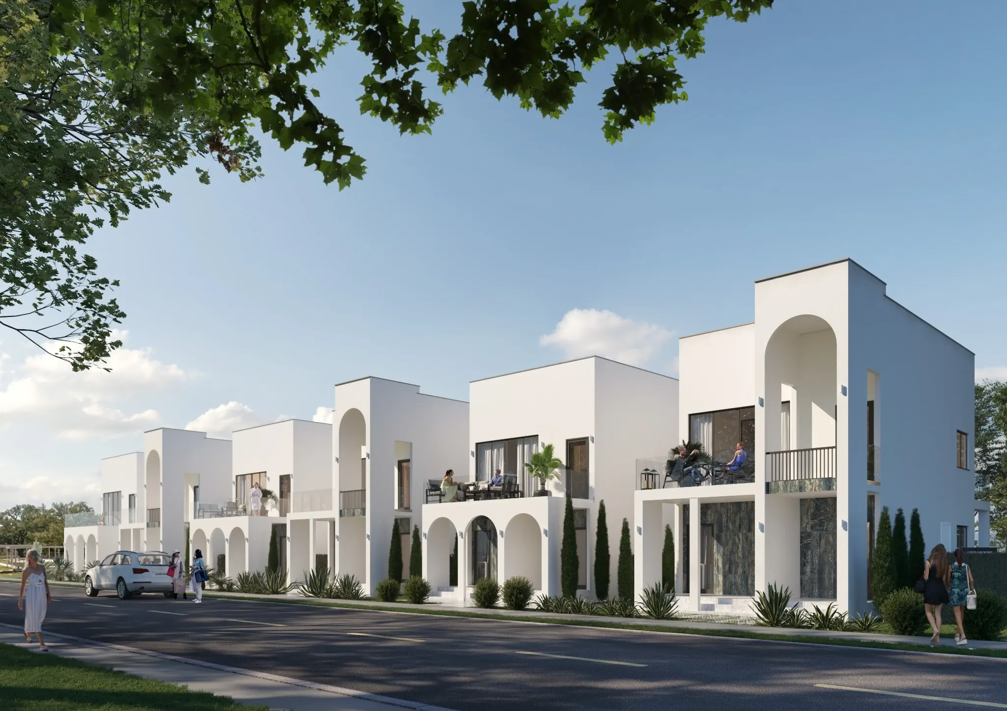Street view of the rental villas with white facades and landscaped entrances.